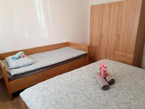 a bedroom with two beds and two shoes on the floor at APARTMA NANA STRUNJAN in Portorož