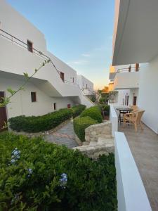 a patio with a table and chairs on a building at Amazones Village Suites in Hersonissos