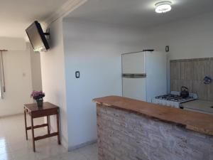 a kitchen with a counter and a stove top oven at DptosECONOMICOS2 in Necochea