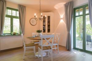 a dining room with a table and chairs at Ferienhaussiedlung Strandperlen Buchenhof 6a (Typ III) in Wustrow