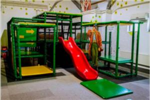 a boy on a slide in a playground at Vakantiehuis 6pers op park 't Broeckhuys in Ewijk groot Zwemplas in het land van Maas & Waal niet voor arbeidsmigranten in Ewijk +25 photos