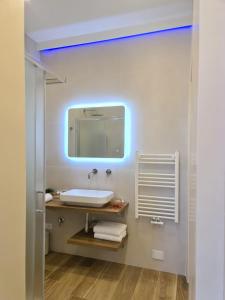 a bathroom with a sink and a mirror at SONI APARTMENT in La Spezia