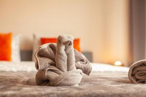 a towel animal sitting on top of a bed at Luxury Suites Central in Antwerp