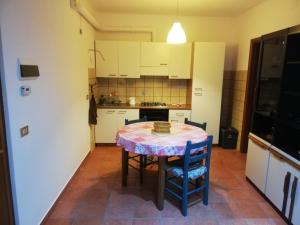 a kitchen with a table and chairs in a room at Casa Rosaguta in Vescina +11 photos
