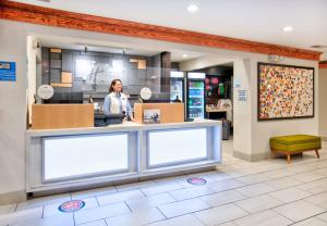a woman standing at a counter in a store at Holiday Inn Express - Hope by IHG in Hope +37 photos