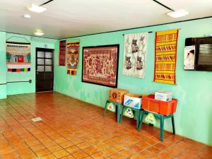 a room with green walls and a tiled floor at The Roof Backpackers in Guadalajara