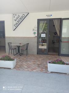 a table and chairs in front of a building at Hotel Danubio in Bellaria-Igea Marina