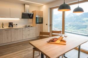 a kitchen with a table with bread and wine glasses at Jaufnerhof in Mareta