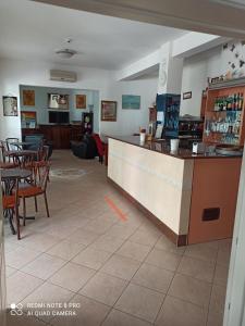 a restaurant with a bar and tables and chairs at Hotel Danubio in Bellaria-Igea Marina