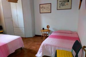 1 dormitorio con 2 camas y mesa. en L' Agave - Appartamento nel cuore del Chianti, en Castelnuovo Berardenga