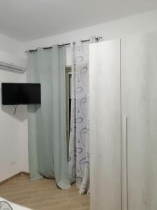TV a/nebo společenská místnost v ubytování AL FARO
