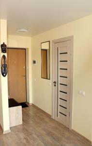 an empty room with a door and a mirror at Golden Dune Apartment in Klaipėda