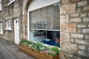 a window of a building with flowers in a window box at Maltings Cottage in Barnard Castle