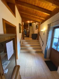 a hallway of a house with wooden floors and stairs at Kur- und Ferienhotel Haser in Oberstaufen