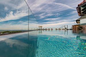 a swimming pool on top of a building at Hotel Irmgard in Strass im Attergau