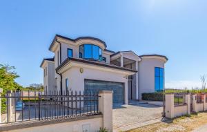 a large white house with a gate at Exclusive VILLA Volme in Banjole