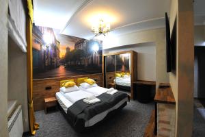 een hotelkamer met 2 bedden en een schilderij aan de muur bij APARTAMENTY NA MNISZEJ in Przemyśl
