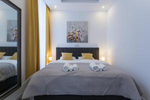 Ein Bett oder Betten in einem Zimmer der Unterkunft Elenas Rooms & Apartment