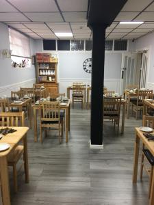 an empty restaurant with wooden tables and chairs at Kingscliff in Blackpool +148 photos