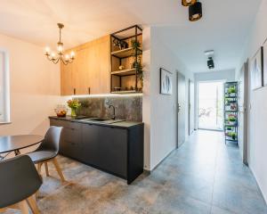 a kitchen with a sink and a table at Willa Krzemień in Sandomierz