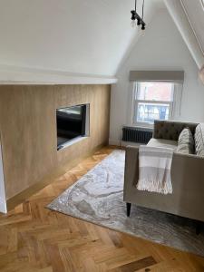 a living room with a couch and a fireplace at The Beach Retreat Whitstable in Kent