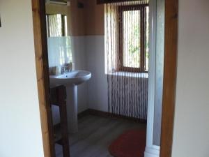a small bathroom with a sink and a window at Maison Charentaise in Les Essards +18 photos
