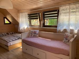 Postel nebo postele na pokoji v ubytování Domki i Apartamenty El-Piero
