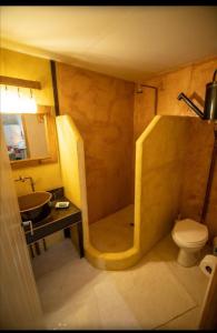 a bathroom with a shower and a toilet and a sink at "Eirini" traditional house Creta Archanes, Αρχάνες σπίτι in Archanes