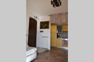 a living room with a couch and a kitchen at Casa vacanze al Castello in Villetta Barrea +41 photos