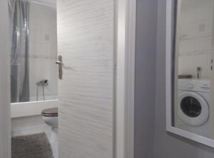 a bathroom with a toilet and a washing machine at Earth n' Water in Verga Kalamata +23 photos