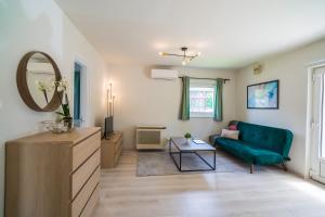 a living room with a blue couch and a mirror at MyFlat Diana Family Apartment in Siófok