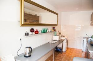 a kitchen with a counter and a mirror on the wall at Bed and Bread in Łeba