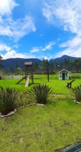 a park with a playground with a swing set at Loft Sahy - Condado Aldeia dos Reis in Mangaratiba