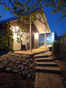 a stone path leading to a house at night at Mizerówka Guest House in Kudowa-Zdrój