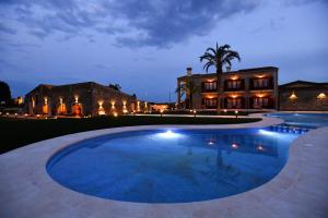 a large swimming pool in front of a house at Hotel Aires de l'Emporda in Vilacolum