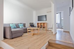 a living room with a couch and a table at Blau Atic Apartment in Barcelona
