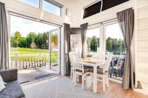 a living room with a table and chairs and a large window at Minivilla by the sea in Dragsfjärd