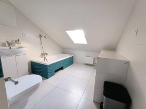 a white bathroom with a sink and a toilet at Firstroom Gdańsk in Gdańsk +41 photos