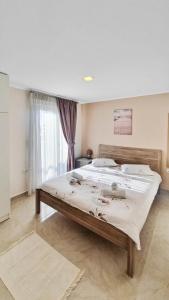 a bedroom with a large bed with white sheets at Seaflows Apartments #1 in Paralia Katerinis