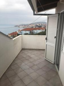 a balcony with a door and a view of the ocean at Apartments Denko - with pool in Kali