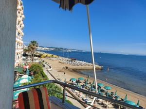 a view of a beach with chairs and umbrellas at Bral Apartments 4 in Durrës