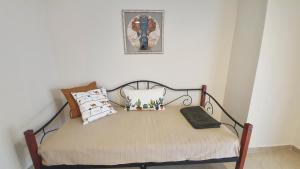 a bed with pillows on it in a room at Seaflows Apartments #1 in Paralia Katerinis