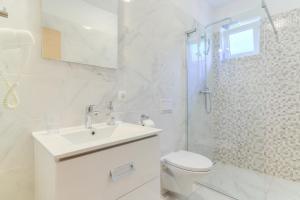a bathroom with a toilet and a sink and a shower at Apartments Jo in Senj +45 photos