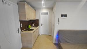 a small kitchen with a bed in a room at Seaflows Apartments #1 in Paralia Katerinis
