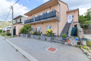 a house with a staircase and a balcony at Apartments Jo in Senj