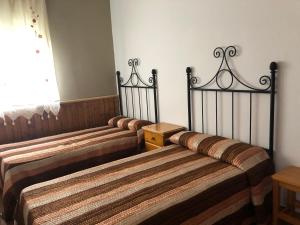 A bed or beds in a room at Alojamiento Noe