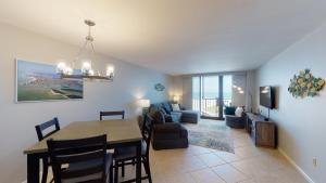 a dining room and living room with a dining table at South Seas Tower 3 #1005 - Beachfront 2/2 Long Beach Views! in Marco Island