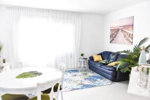 a living room with a couch and a table at The Light House II, with rooftop and parking in Nazaré