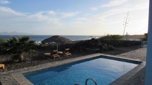 a swimming pool with a view of the ocean at Cap-Azul in Porto Novo