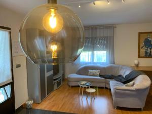 a living room with a couch and a large glass ceiling at Apartamento Sanxenxo Vilalonga in Sanxenxo